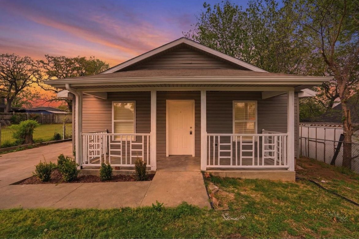 Front porch of a rent to own home in west Tulsa at dusk